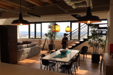 Small urban medium tone wood floor and brown floor great room photo in Mexico City with white walls