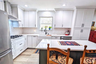 Inspiration for a mid-sized eclectic l-shaped vinyl floor eat-in kitchen remodel in Other with a farmhouse sink, shaker cabinets, quartz countertops, white backsplash, ceramic backsplash, stainless steel appliances and white countertops