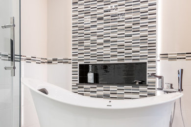 Example of a mid-sized trendy master black and white tile and porcelain tile porcelain tile bathroom design in Ottawa with flat-panel cabinets, dark wood cabinets, a one-piece toilet, gray walls, a vessel sink and quartz countertops