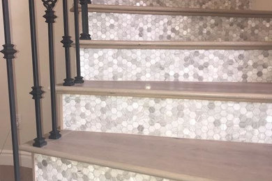 Large trendy wooden curved mixed material railing staircase photo in San Diego with tile risers