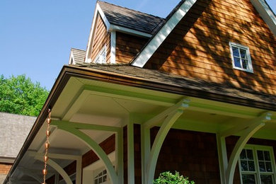 Example of a huge classic white two-story wood gable roof design in New York