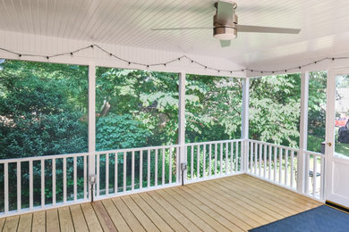 Mid-sized elegant screened-in and wood railing back porch photo in Baltimore with decking and a roof extension