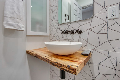 Example of a small 1960s kids' black and white tile and ceramic tile porcelain tile, black floor and single-sink bathroom design in St Louis with medium tone wood cabinets, a bidet, white walls, a vessel sink, wood countertops and a floating vanity