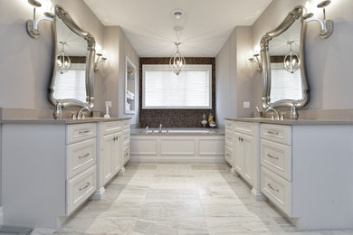 Design ideas for a mid-sized contemporary master bathroom in Toronto with recessed-panel cabinets, white cabinets, an undermount tub, a one-piece toilet, mosaic tile, grey walls, marble floors, an undermount sink, engineered quartz benchtops, an alcove shower, brown tile, multi-coloured tile and grey floor.