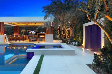 Photo of a contemporary backyard patio in Orange County with a water feature.