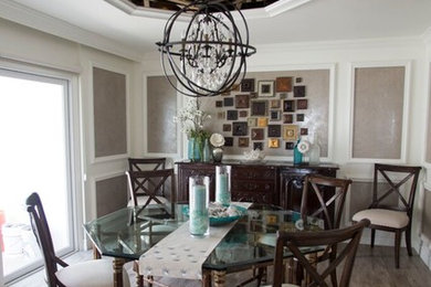 Large transitional medium tone wood floor and brown floor enclosed dining room photo in Orange County with multicolored walls and no fireplace