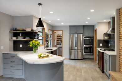Inspiration for a mid-sized transitional u-shaped open plan kitchen in Minneapolis with an undermount sink, shaker cabinets, grey cabinets, quartzite benchtops, grey splashback, porcelain splashback, stainless steel appliances, porcelain floors, a peninsula, grey floor and white benchtop.