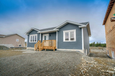 Example of a small classic blue one-story vinyl exterior home design in Other with a shingle roof