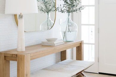 Inspiration for a coastal light wood floor and beige floor single front door remodel in San Francisco with white walls and a white front door