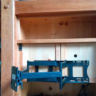 Design ideas for a medium sized contemporary open plan home cinema in Manchester with blue walls, light hardwood flooring and a wall mounted tv.