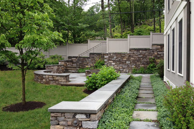 This is an example of a large contemporary full sun backyard concrete paver garden path in New York for fall.
