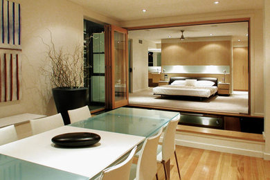 Large master light wood floor and brown floor bedroom photo in Hawaii with beige walls and no fireplace
