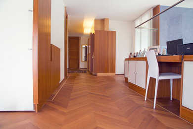 Design ideas for a large contemporary hallway in Venice with white walls and light hardwood floors.