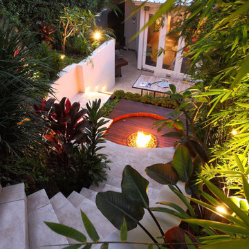 Outdoor Entertaining Yard with Retaining Walls and Curved Access Steps in Sherma