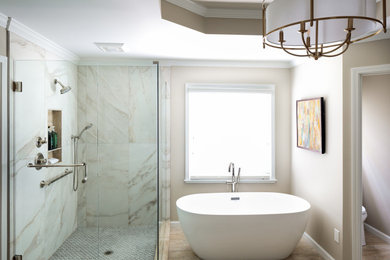 Inspiration for a large transitional master bathroom in Atlanta with raised-panel cabinets, green cabinets, a freestanding tub, a corner shower, a two-piece toilet, white tile, porcelain tile, beige walls, travertine floors, an undermount sink, quartzite benchtops, beige floor, a hinged shower door, multi-coloured benchtops, a niche, a double vanity, a built-in vanity and recessed.
