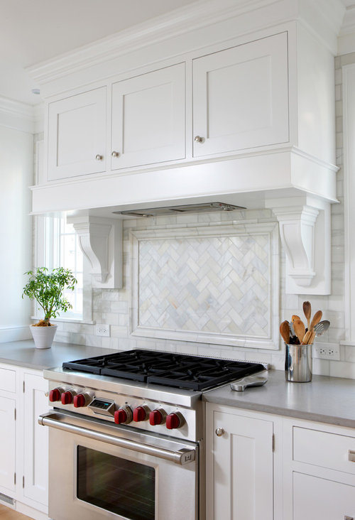 kitchen backsplash and picture frame above stove under hood