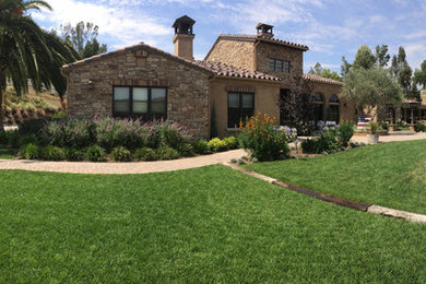 This is an example of a mediterranean backyard landscaping in Los Angeles.