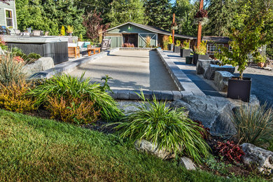 Photo of a large modern backyard full sun outdoor sport court for summer in Seattle with a fire feature and concrete pavers.