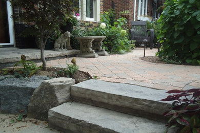 Mid-sized trendy brick front porch idea in Toronto