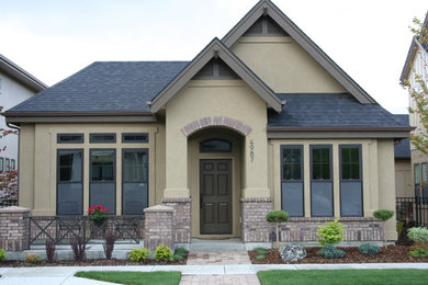 Photo of a large traditional two-storey beige exterior in Boise with mixed siding and a clipped gable roof.