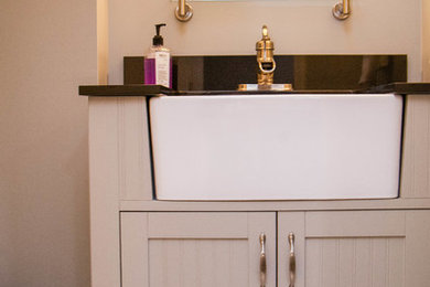 Example of a small minimalist kids' multicolored tile and stone tile mosaic tile floor bathroom design in Chicago with a vessel sink, furniture-like cabinets, gray cabinets, quartzite countertops, a two-piece toilet and gray walls