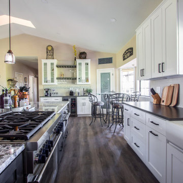 Spacious kitchen remodel using warm taupe, white and brown tones