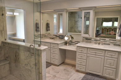 Inspiration for a mid-sized transitional master bathroom in Sacramento with raised-panel cabinets, grey cabinets, an alcove shower, gray tile, ceramic tile, grey walls, ceramic floors, an undermount sink, engineered quartz benchtops, grey floor, a hinged shower door and grey benchtops.