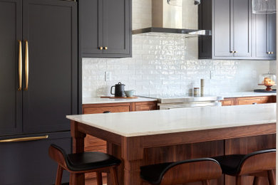 Inspiration for a mid-sized transitional l-shaped medium tone wood floor and brown floor enclosed kitchen remodel in New York with an undermount sink, shaker cabinets, dark wood cabinets, marble countertops, white backsplash, subway tile backsplash, colored appliances, an island and white countertops