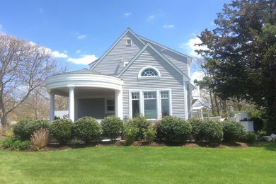 Mid-sized beach style gray two-story wood exterior home photo in Other with a shingle roof