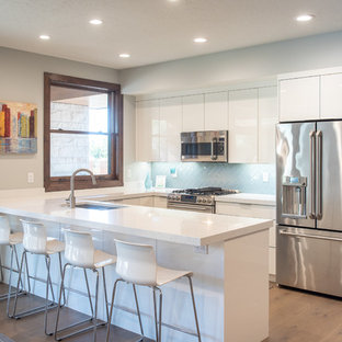 Large contemporary kitchen pantry inspiration - Example of a large trendy u-shaped kitchen pantry design in Salt Lake City with flat-panel cabinets, white cabinets and an island