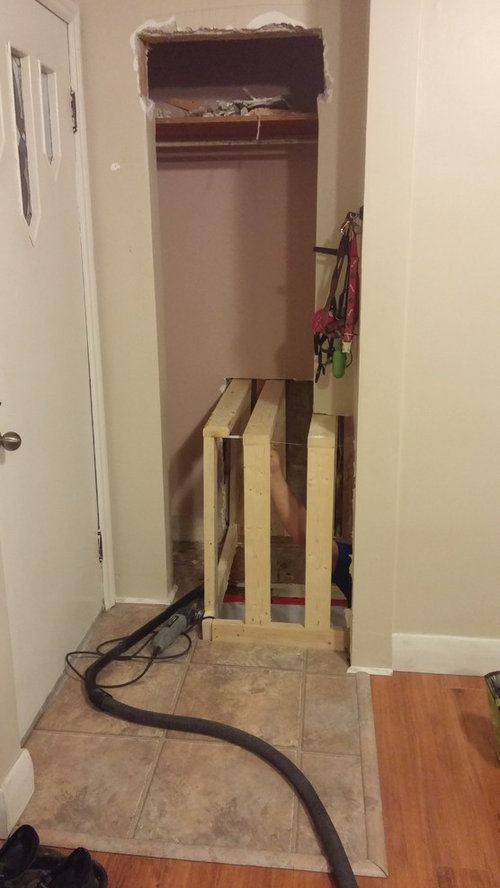 Front hall closet with basement stair bulkhead