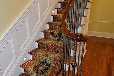 Inspiration for a large timeless wooden straight staircase remodel in New Orleans with wooden risers