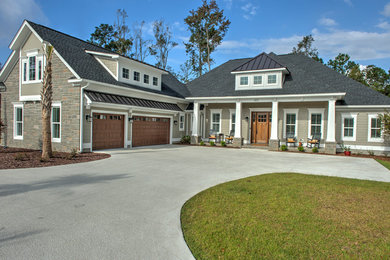 Craftsman green two-story mixed siding house exterior idea in Other with a hip roof and a mixed material roof