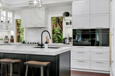 This is an example of a large modern l-shaped open plan kitchen in Melbourne with with island.