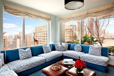 This is an example of an eclectic living room in New York with blue walls, carpet and blue floor.