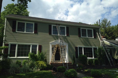 Large traditional green two-story vinyl gable roof idea in Newark