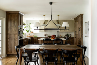 Inspiration for a mid-sized transitional medium tone wood floor and brown floor kitchen/dining room combo remodel in Detroit with beige walls