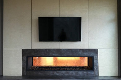 Inspiration for a large contemporary enclosed dark wood floor living room remodel in Chicago with a music area, beige walls, a two-sided fireplace, a stone fireplace and a media wall