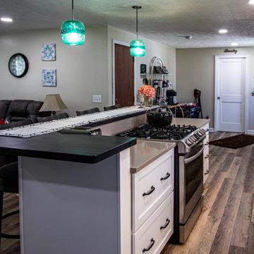 White Kitchen with Blue Tiled Backsplash and Two Tier Island