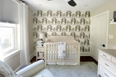 Example of a small cottage boy vinyl floor, brown floor and wallpaper nursery design in Philadelphia with beige walls