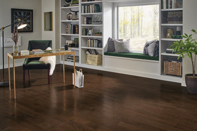 Study room - mid-sized transitional built-in desk medium tone wood floor and brown floor study room idea in New York with beige walls