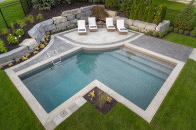 Small trendy backyard stone and custom-shaped pool photo in Toronto