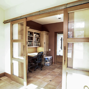 Inspiration for a mid-sized mediterranean study room in San Francisco with beige walls, travertine floors, a freestanding desk and beige floor.