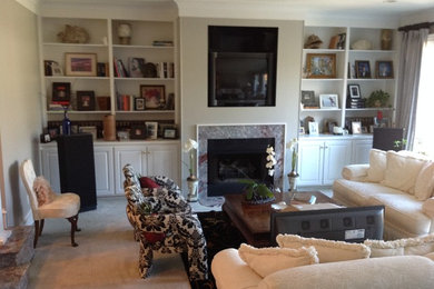 Living room - mid-sized transitional formal and enclosed living room idea in Other with white walls and a media wall