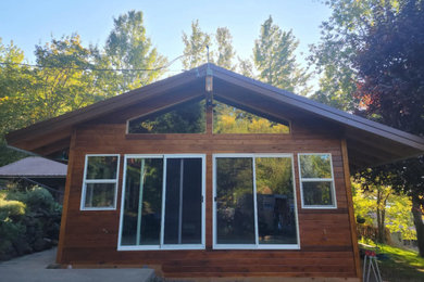 Mid-sized traditional one-story wood house exterior idea in Other
