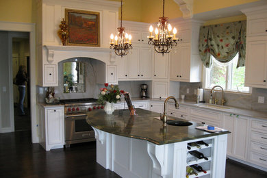Mid-sized l-shaped dark wood floor eat-in kitchen photo in Grand Rapids with a drop-in sink, marble countertops, stainless steel appliances and an island