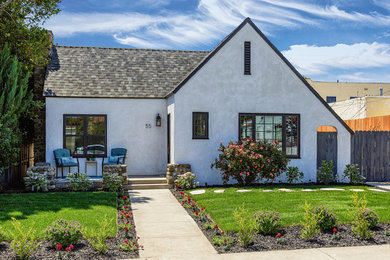 Small contemporary white one-story stucco house exterior idea in Los Angeles with a shingle roof