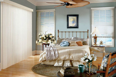 Example of a mid-sized beach style master light wood floor and brown floor bedroom design in Toronto with blue walls and no fireplace
