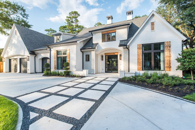 Inspiration for a large coastal white two-story brick exterior home remodel in Houston with a mixed material roof