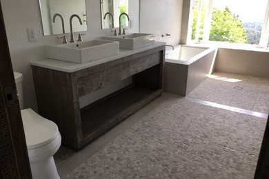 Inspiration for a mid-sized country master wet room bathroom in Los Angeles with a corner tub, gray tile, porcelain tile and marble benchtops.